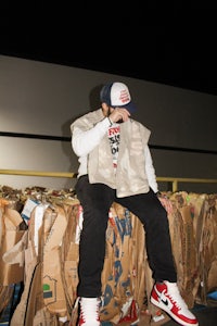 a man sitting on top of cardboard boxes